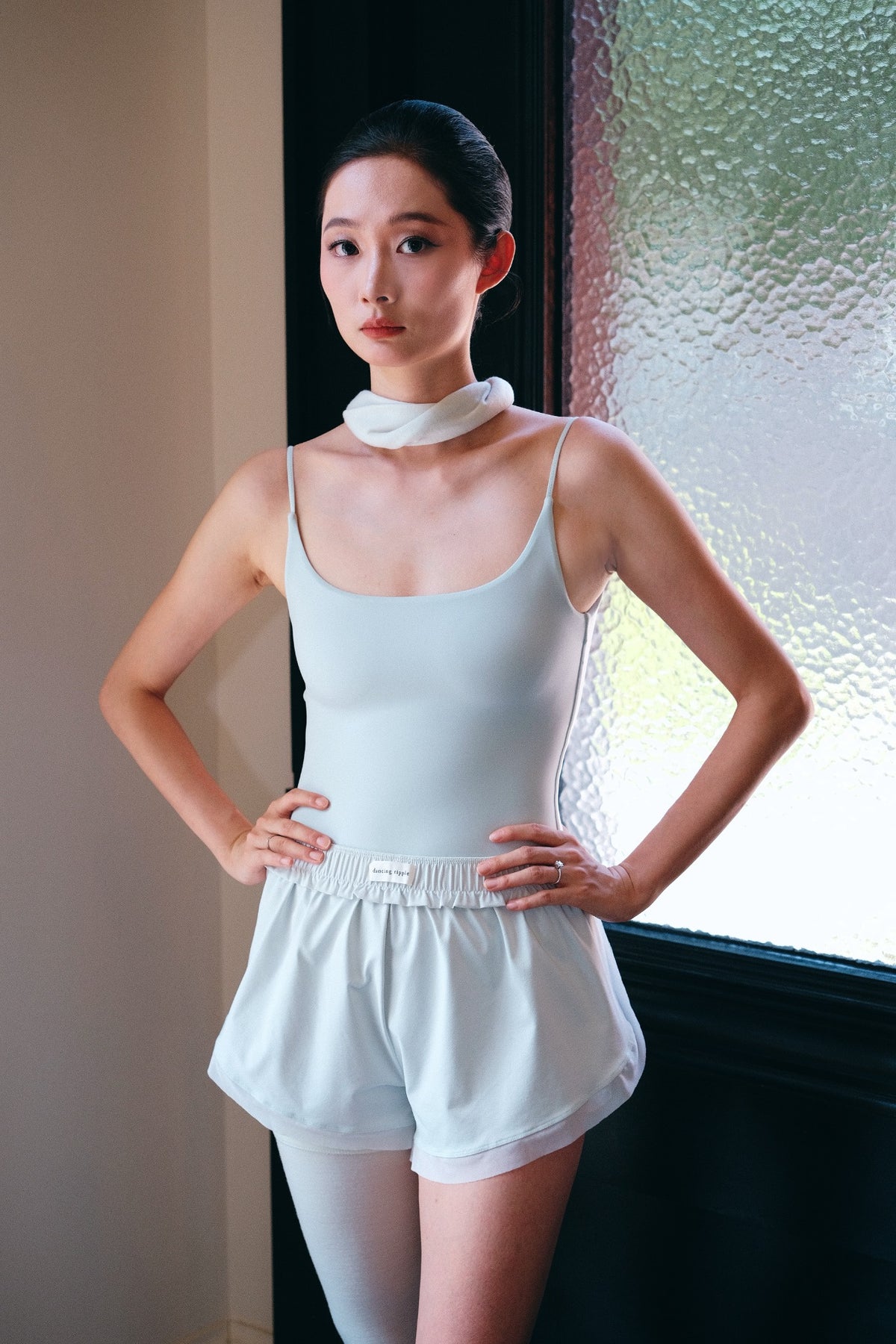 Ballet dancer in Bloom Overlap Dance Shorts showing the front view of the Misted Jade dance shorts with overlapping side panels