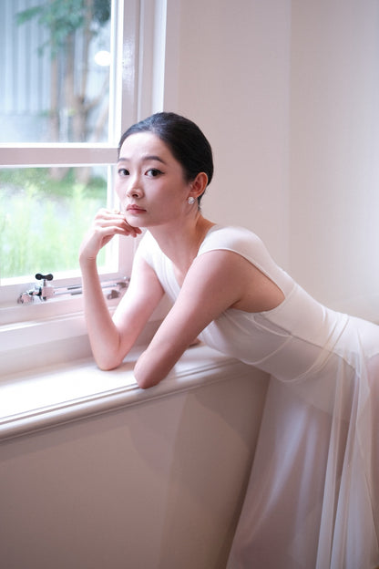 Dancer in a Dawn White Pull-On Full-Circle Ballet Rehearsal Skirt over a matching leotard 