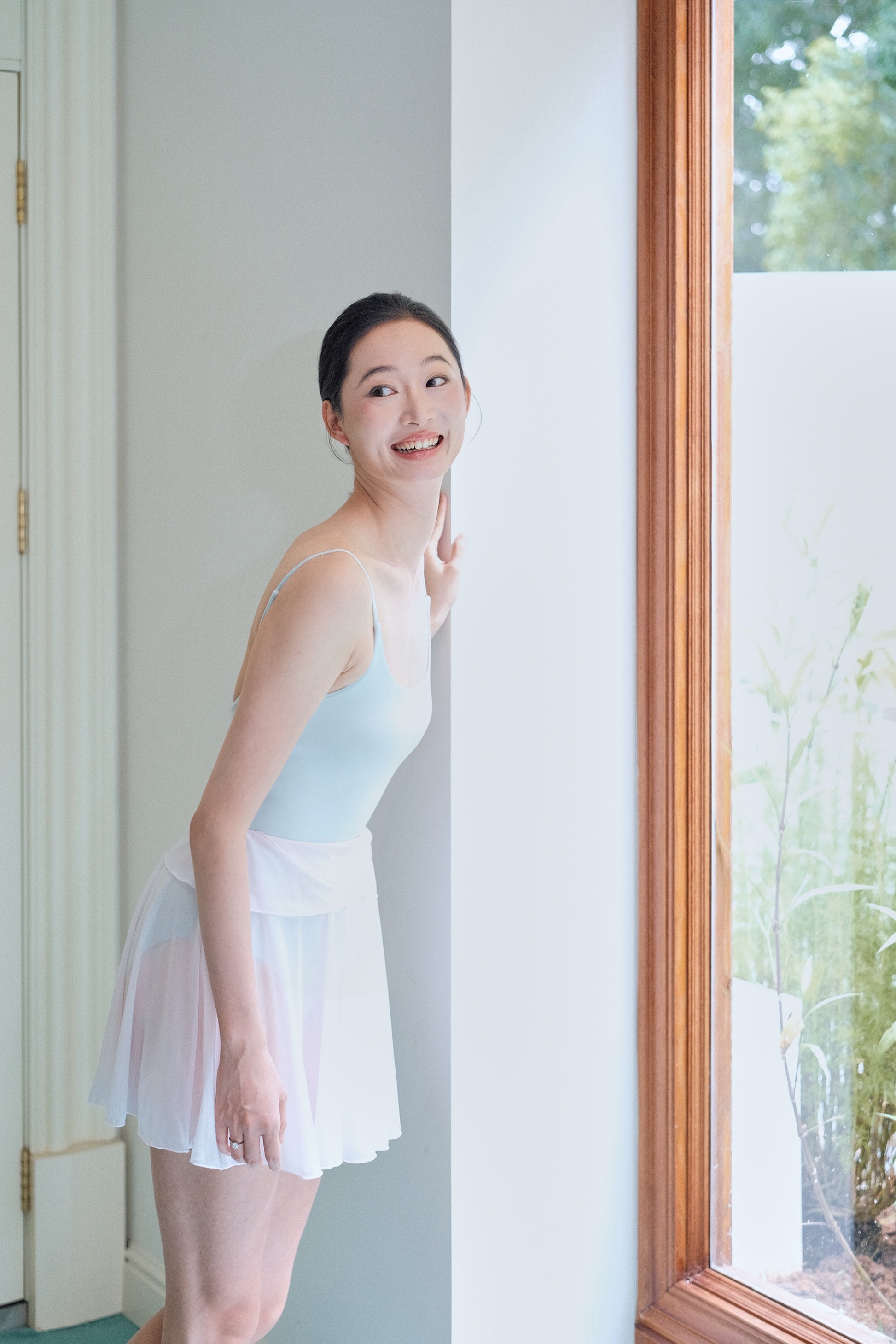Twin-petal wrap mini skirt in Dawn Pink from the Chasing Light dancewear collection