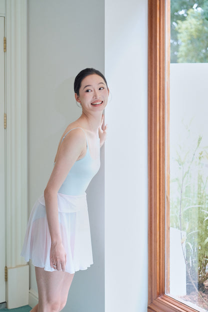 Twin-petal wrap mini skirt in Dawn Pink from the Chasing Light dancewear collection