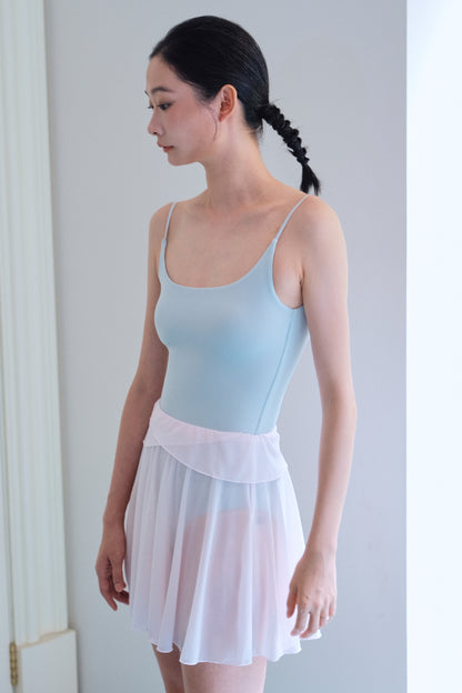 Detail of GRS-certified recycled mesh fabric on soft pink twin-petal ballet mini skirt