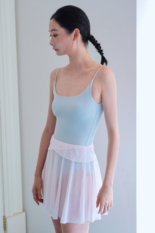 Detail of GRS-certified recycled mesh fabric on soft pink twin-petal ballet mini skirt