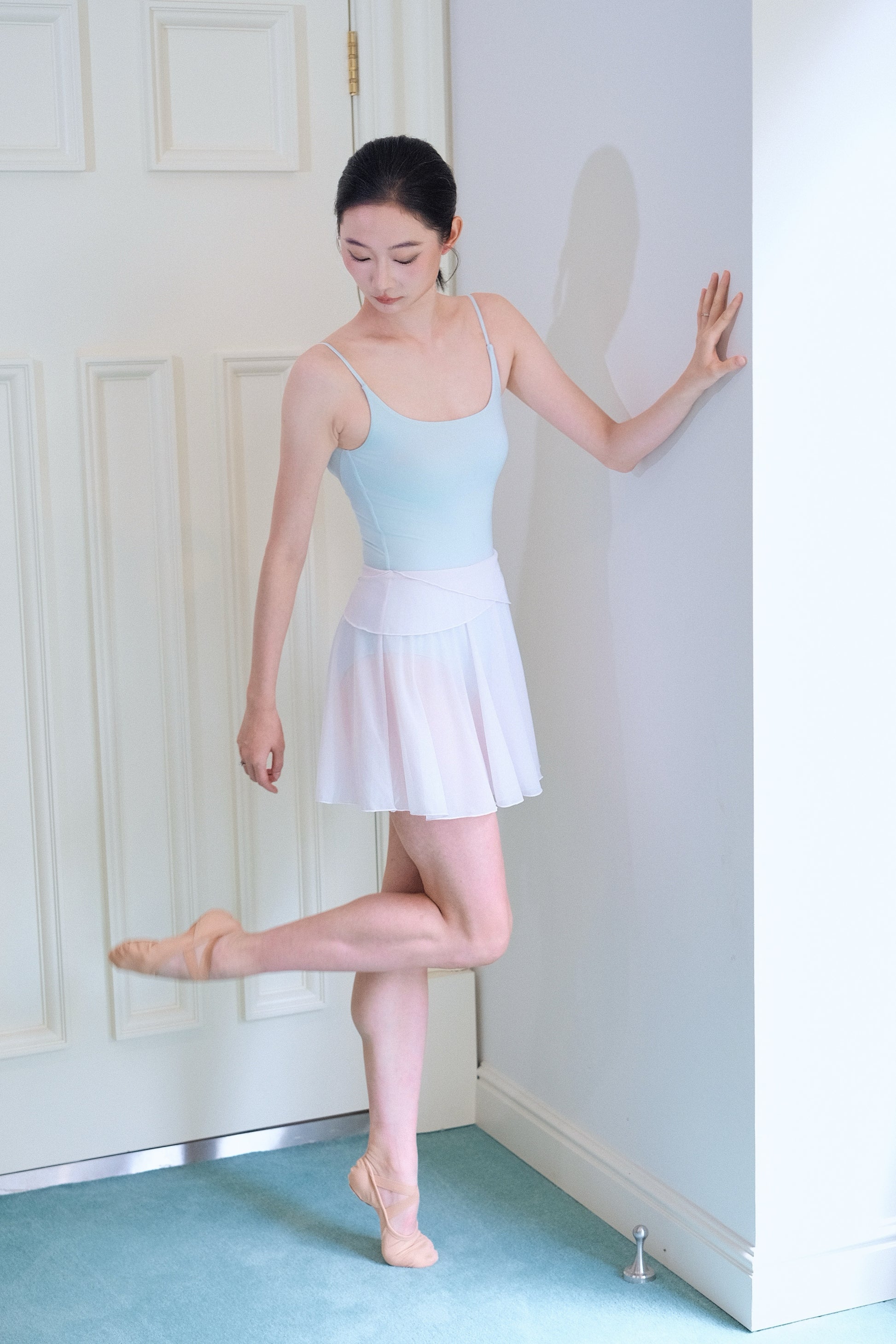 Dancer wears light pink twin-petal Skirt mini in bright studio