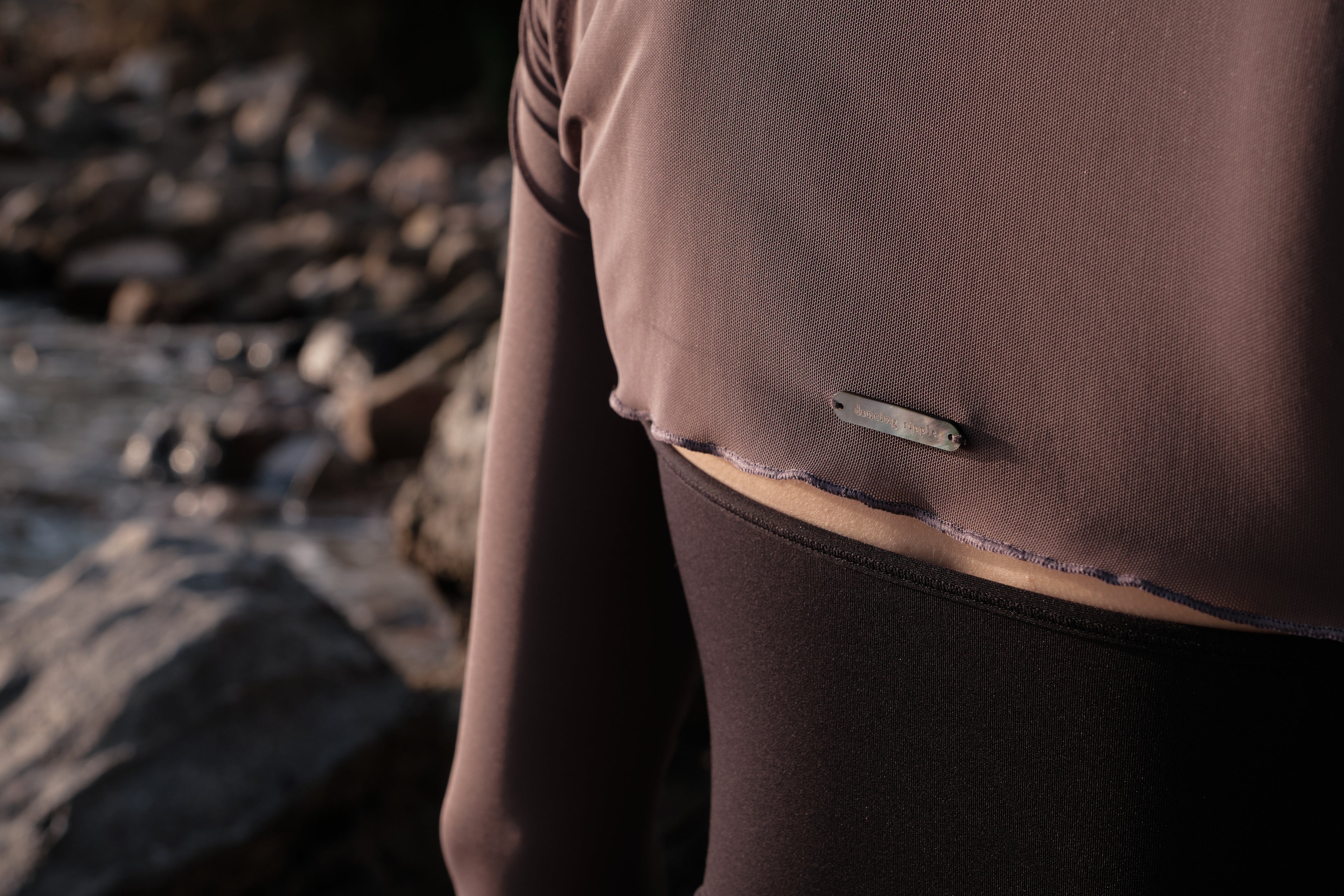 Ultra-Stretch Ballet Mesh Shrug features a hand-sewn logo tag of imported natural Black Mother-of-Pearl in the back for a refined detail